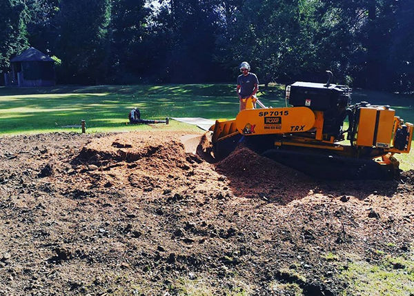 Specialist stump grinding equipment removing a tree stump from a garden in Oakham